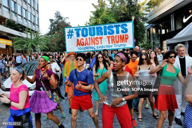 Women seen shouting slogans during the protest. Tourists took part in the demonstration named, Tourists against Trump in the capital city of Greece...