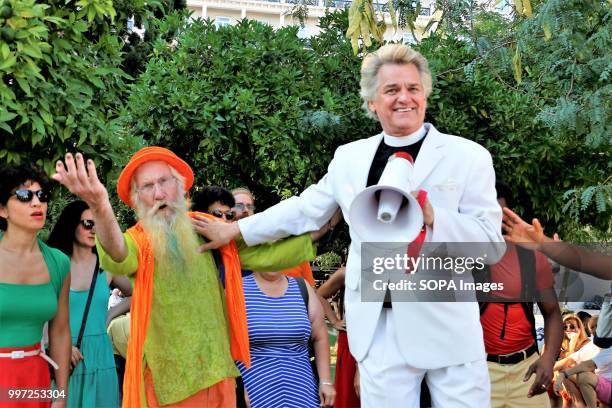 Man dressed as a preacher seen holding a mega phone during the protest. Tourists took part in the demonstration named, Tourists against Trump in the...