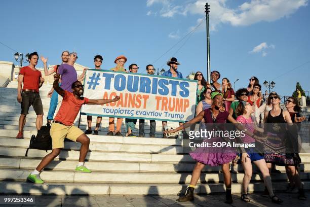 Protesters seen holding a banner during the protest on Syntagma Square. Tourist have taken part in the demonstration named, Tourist against Trump in...