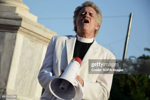 Protester seen shouting slogans with a mega phone during the demonstration on Syntagma Square. Tourist have taken part in the demonstration named,...