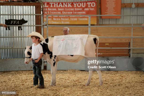 Young boy participates in a dairy promotion at the Iowa County Fair on July 12, 2018 in Marengo, Iowa. The fair, like many in counties throughout the...