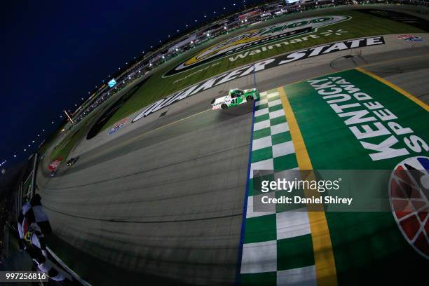 Ben Rhodes, driver of the The Carolina Nut Co. Ford, takes the checkered flag to win the NASCAR Camping World Truck Series Buckle Up in Your Truck...