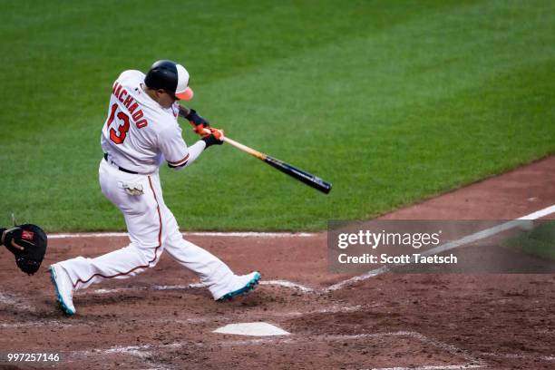 Manny Machado of the Baltimore Orioles hits an RBI single against the Philadelphia Phillies during the sixth inning at Oriole Park at Camden Yards on...