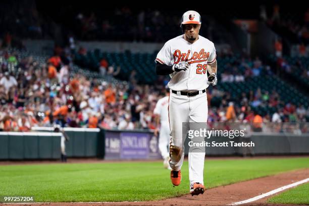 Jace Peterson of the Baltimore Orioles scores against the Philadelphia Phillies during the seventh inning at Oriole Park at Camden Yards on July 12,...
