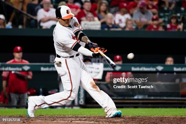 Manny Machado of the Baltimore Orioles singles against the Philadelphia Phillies during the eighth inning at Oriole Park at Camden Yards on July 12,...