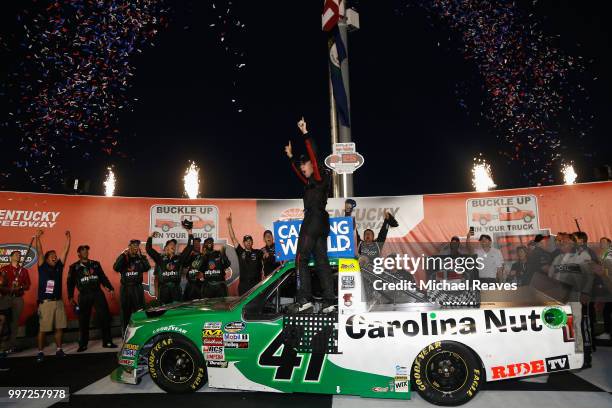 Ben Rhodes, driver of the The Carolina Nut Co. Ford, celebrates in Victory Lane after winning the NASCAR Camping World Truck Series Buckle Up in Your...