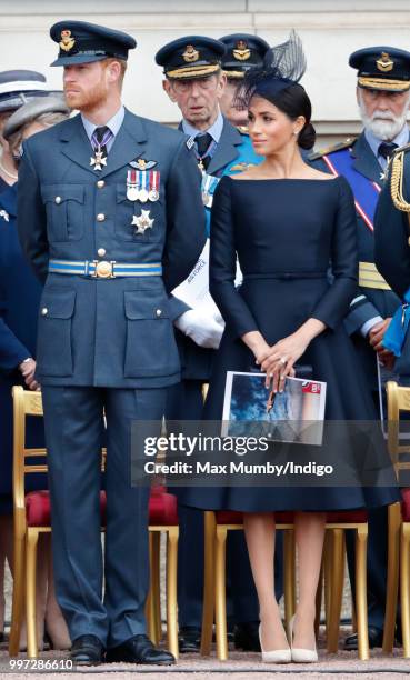 Prince Harry, Duke of Sussex and Meghan, Duchess of Sussex attend a ceremony to mark the centenary of the Royal Air Force on the forecourt of...