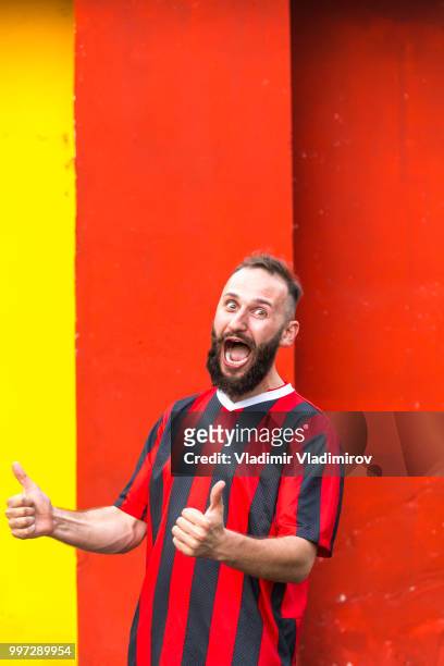 cheerful football fan celebrating, thumbs up - traditional sport stock pictures, royalty-free photos & images