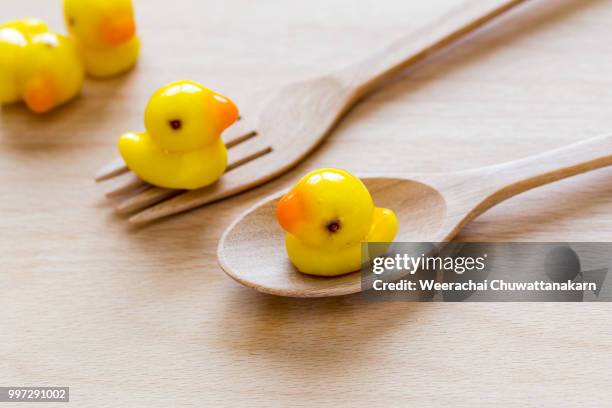 deletable imitation fruits in duck shape on wooden block - wooden block stockfoto's en -beelden