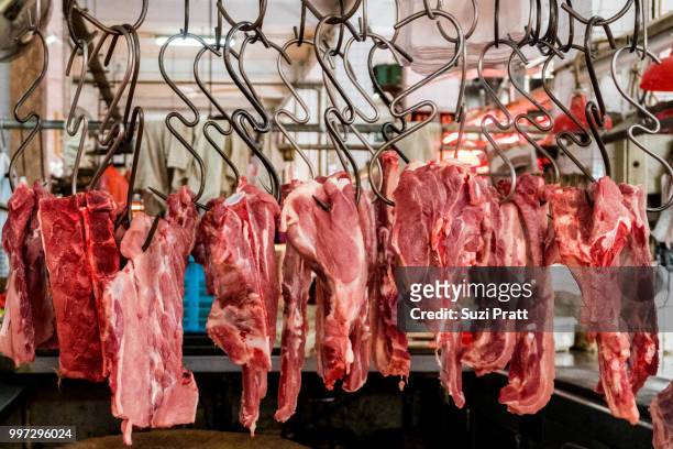 butcher at the red market in macau. - suzi pratt stock pictures, royalty-free photos & images
