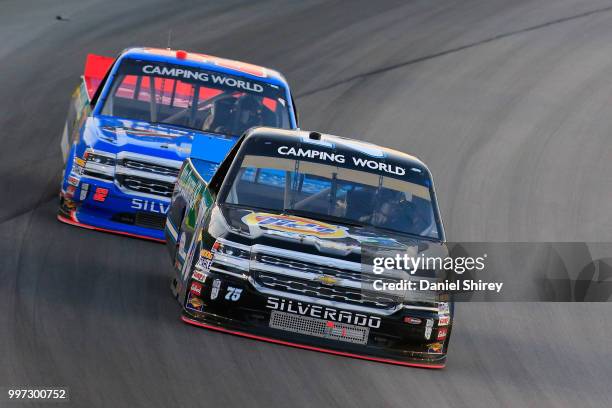 Parker Kligerman, driver of the Food Country USA Chevrolet, leads Stewart Friesen, driver of the We Build America Chevrolet, during the NASCAR...