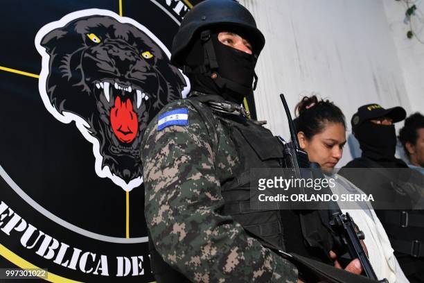 Members of Honduras' new Anti-Gangs National Force guard alleged gang members arrested on the first day of operations, during their presentation to...
