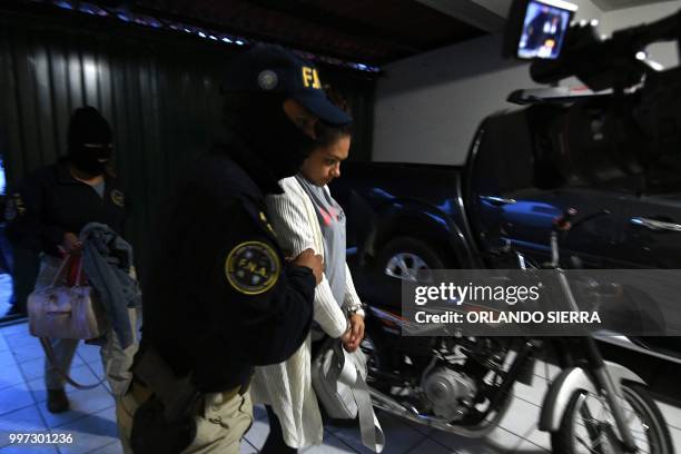 Members of Honduras' new Anti-Gangs National Force escort an alleged gang member after her arrested on the first day of operations, in Tegucigalpa on...