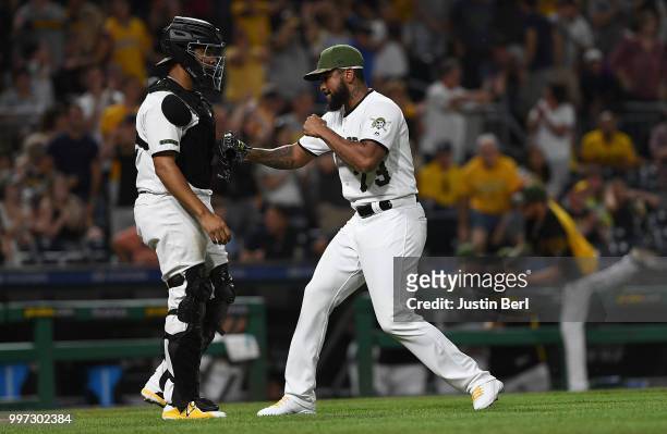 Felipe Vazquez of the Pittsburgh Pirates celebrates with Elias Diaz after defeating the Milwaukee Brewers 6-3 at PNC Park on July 12, 2018 in...