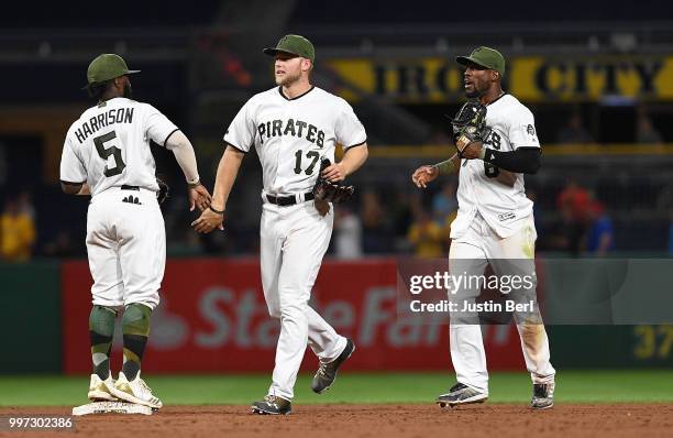 Josh Harrison of the Pittsburgh Pirates celebrates with Austin Meadows after the final out in a 6-3 win over the Milwaukee Brewers at PNC Park on...