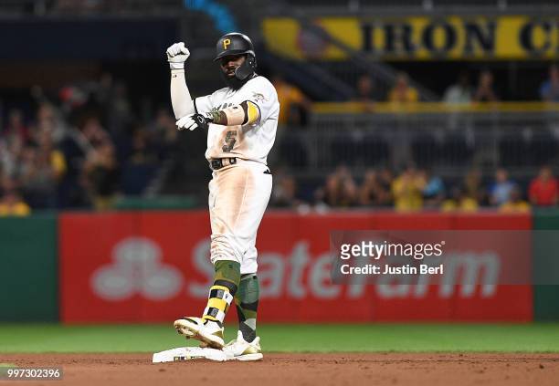 Josh Harrison of the Pittsburgh Pirates reacts after hitting an RBI double to left field in the seventh inning during the game against the Milwaukee...