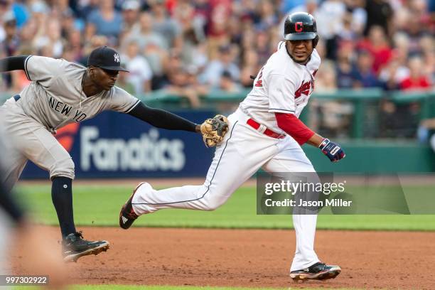 Shortstop Didi Gregorius of the New York Yankees runs down Edwin Encarnacion of the Cleveland Indians during the third inning at Progressive Field on...