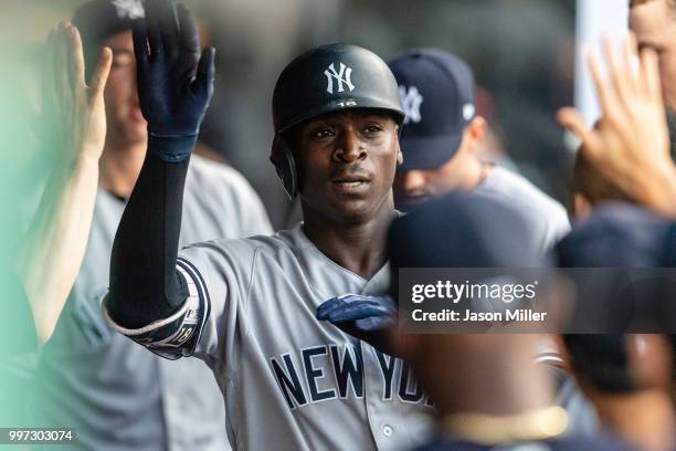 Didi Gregorius of the New York Yankees celebrates in the dugout after hitting a solo homer during the fourth inning against the Cleveland Indians at...