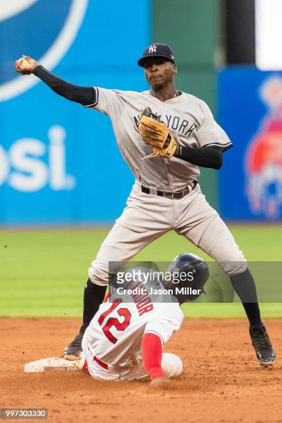 Didi Gregorius of the New York Yankees throws out Michael Brantley of the Cleveland Indians at first as Francisco Lindor is out at second for a...