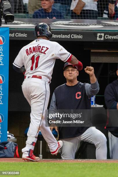 Jose Ramirez of the Cleveland Indians celebrates with manager Terry Francona after hitting a solo home run to right during the fifth inning against...