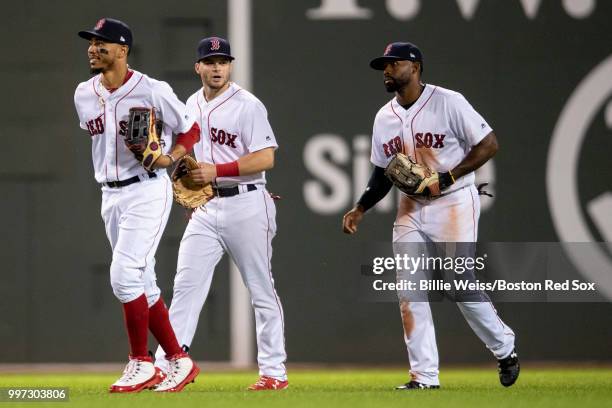 Mookie Betts, Jackie Bradley Jr. #19, and Andrew Benintendi of the Boston Red Sox celebrate a victory against the Toronto Blue Jays on July 12, 2018...