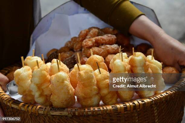 a basket of sweets in hanoi, vietnam. - almut albrecht stockfoto's en -beelden
