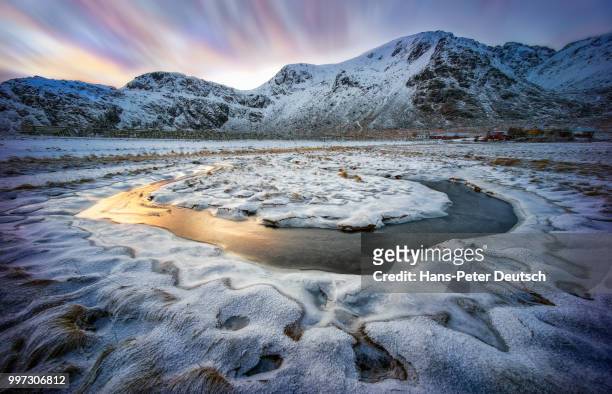a frozen stream near mountains. - deutsch stock pictures, royalty-free photos & images