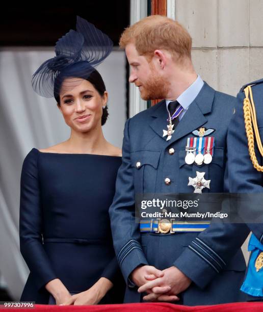 Meghan, Duchess of Sussex and Prince Harry, Duke of Sussex watch a flypast to mark the centenary of the Royal Air Force from the balcony of...