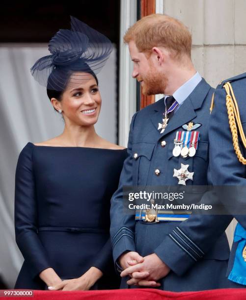 Meghan, Duchess of Sussex and Prince Harry, Duke of Sussex watch a flypast to mark the centenary of the Royal Air Force from the balcony of...