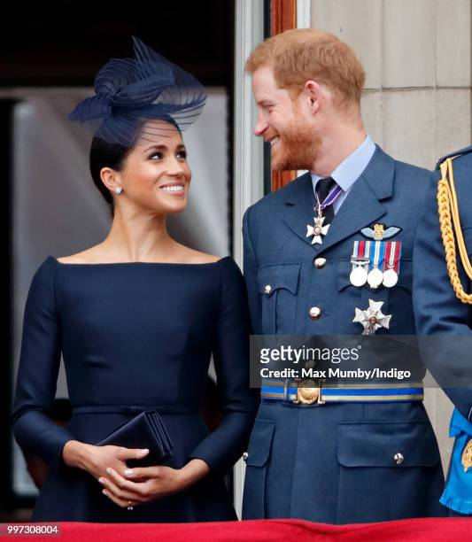 Meghan, Duchess of Sussex and Prince Harry, Duke of Sussex watch a flypast to mark the centenary of the Royal Air Force from the balcony of...