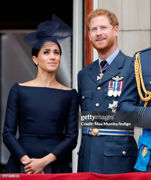 Meghan, Duchess of Sussex and Prince Harry, Duke of Sussex watch a flypast to mark the centenary of the Royal Air Force from the balcony of...