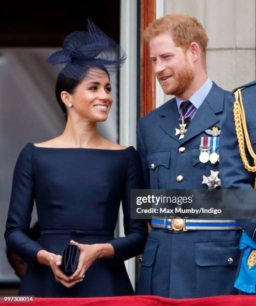 Meghan, Duchess of Sussex and Prince Harry, Duke of Sussex watch a flypast to mark the centenary of the Royal Air Force from the balcony of...