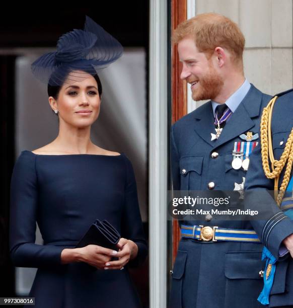 Meghan, Duchess of Sussex and Prince Harry, Duke of Sussex watch a flypast to mark the centenary of the Royal Air Force from the balcony of...