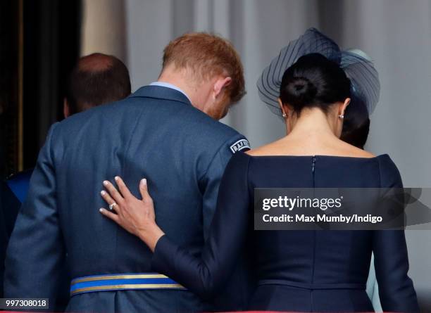 Meghan, Duchess of Sussex and Prince Harry, Duke of Sussex watch a flypast to mark the centenary of the Royal Air Force from the balcony of...