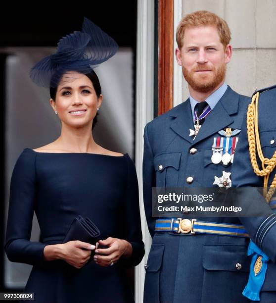 Meghan, Duchess of Sussex and Prince Harry, Duke of Sussex watch a flypast to mark the centenary of the Royal Air Force from the balcony of...