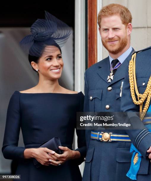 Meghan, Duchess of Sussex and Prince Harry, Duke of Sussex watch a flypast to mark the centenary of the Royal Air Force from the balcony of...