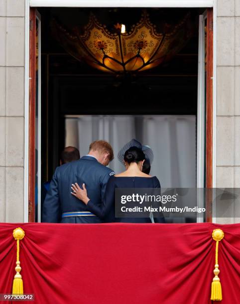 Meghan, Duchess of Sussex and Prince Harry, Duke of Sussex watch a flypast to mark the centenary of the Royal Air Force from the balcony of...