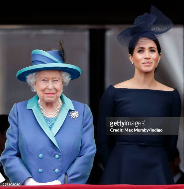 Queen Elizabeth II and Meghan, Duchess of Sussex watch a flypast to mark the centenary of the Royal Air Force from the balcony of Buckingham Palace...