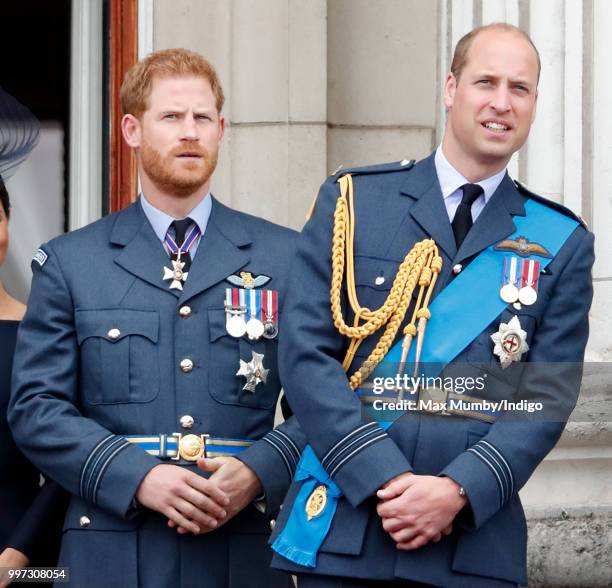 Prince Harry, Duke of Sussex and Prince William, Duke of Cambridge watch a flypast to mark the centenary of the Royal Air Force from the balcony of...