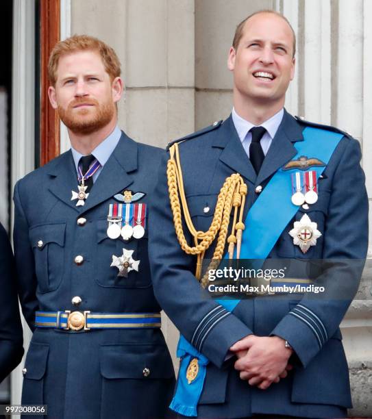 Prince Harry, Duke of Sussex and Prince William, Duke of Cambridge watch a flypast to mark the centenary of the Royal Air Force from the balcony of...