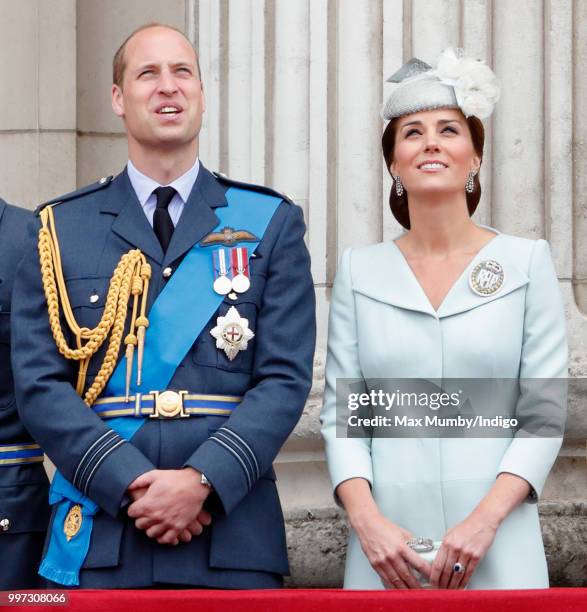 Prince William, Duke of Cambridge and Catherine, Duchess of Cambridge watch a flypast to mark the centenary of the Royal Air Force from the balcony...