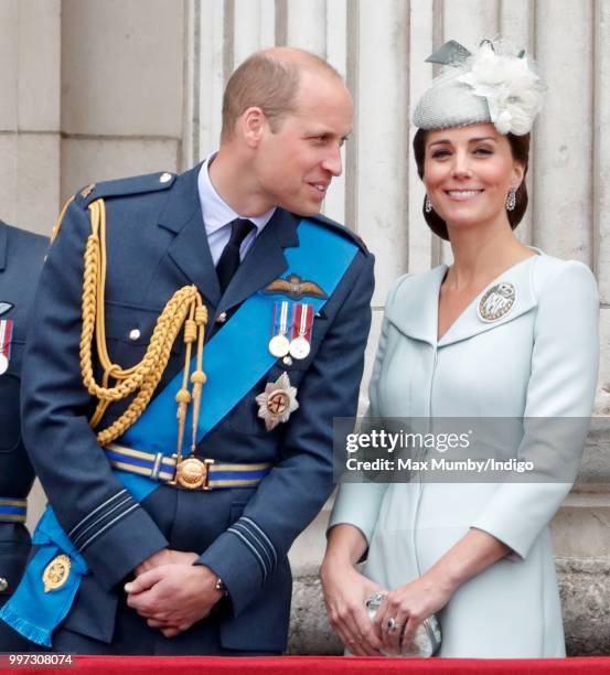 Prince William, Duke of Cambridge and Catherine, Duchess of Cambridge watch a flypast to mark the centenary of the Royal Air Force from the balcony...