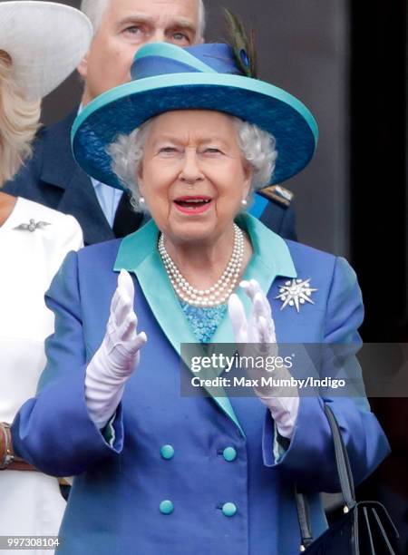 Queen Elizabeth II watches a flypast to mark the centenary of the Royal Air Force from the balcony of Buckingham Palace on July 10, 2018 in London,...