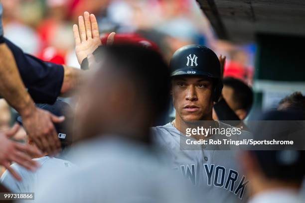 Aaron Judge of the New York Yankees gets greeted by his teammates after scoring a run during the game against the Philadelphia Phillies at Citizens...