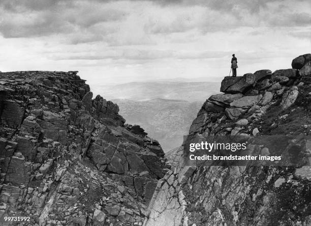 Lone holidaymaker on top of the 3786 feet high Lochnagar which gives a nice view of Deeside and the surrounding country. Photograph. Scotland. 1937.