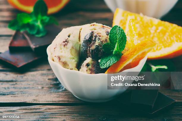 ice cream with orange and mint - mint ice cream stock pictures, royalty-free photos & images