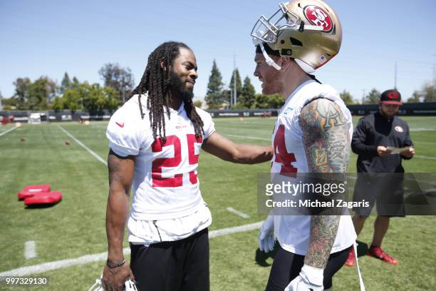 Richard Sherman and Cassius Marsh of the San Francisco 49ers talk on the field during the team Mini Camp at the SAP Training Facility on June 12,...