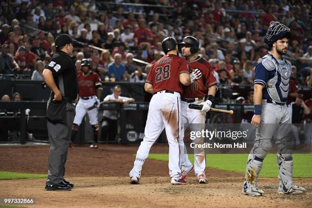 Pollock of the Arizona Diamondbacks is being held back by teammate Steven Souza Jr after being ejected for arguing balls and strikes with home plate...