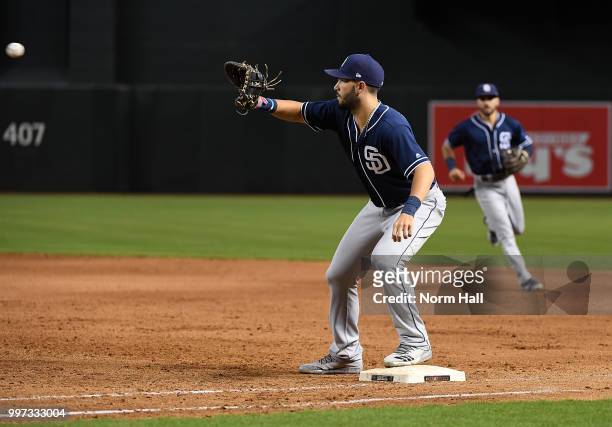 Eric Hosmer of the San Diego Padres catches a throw while covering first base against the Arizona Diamondbacks at Chase Field on July 8, 2018 in...