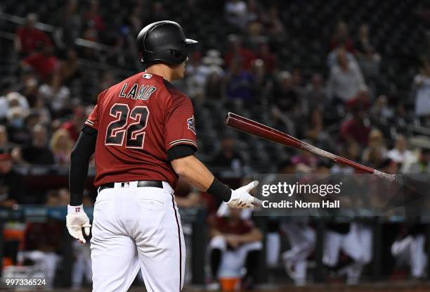 Jake Lamb of the Arizona Diamondbacks flips his bat after striking out against the San Diego Padres at Chase Field on July 8, 2018 in Phoenix,...